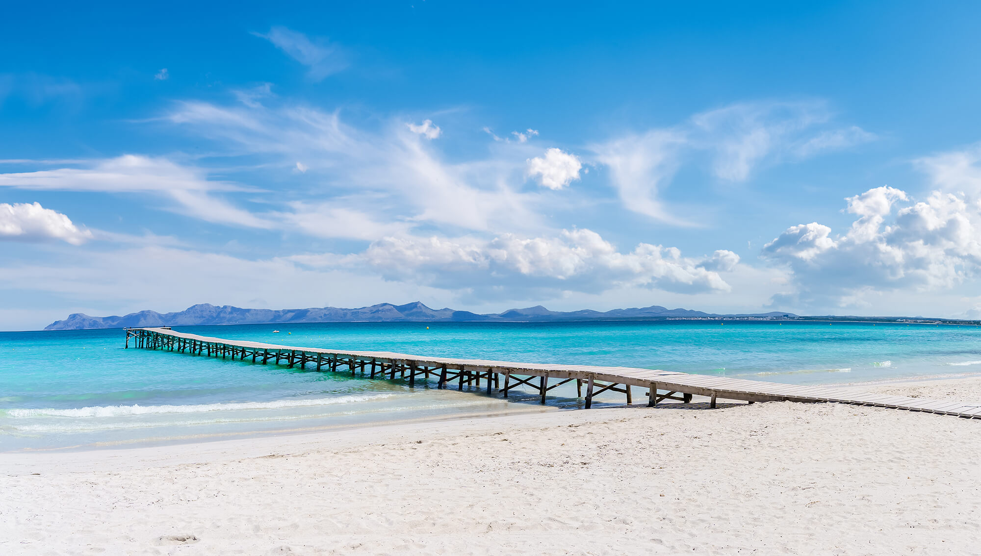 Wooden jetty on the coast of Platja de Muro in the Bay of Alcudia